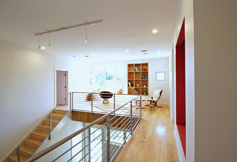 Open den and double height living space. Photo by Mina Brinkey.