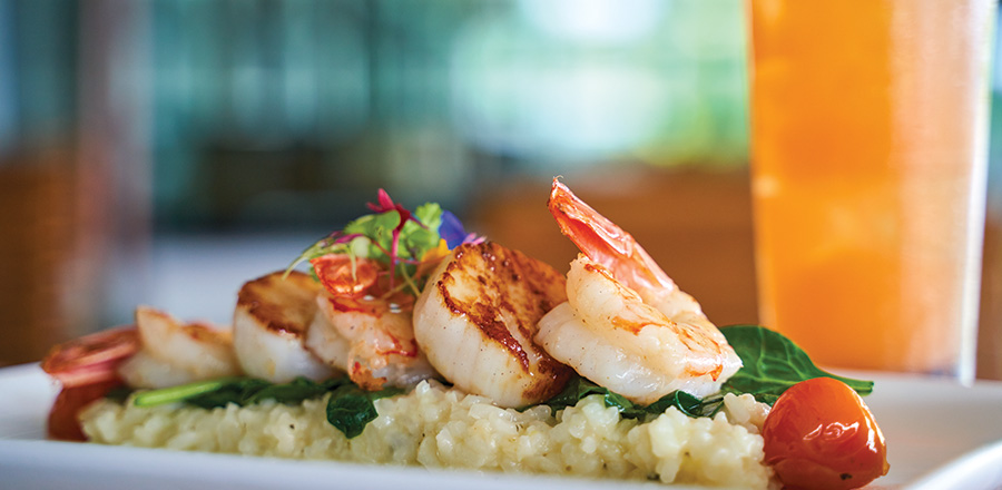 Key West shrimp and scallop with lemon risotto, local greens, lemon beurre blanc and tomato confit. 