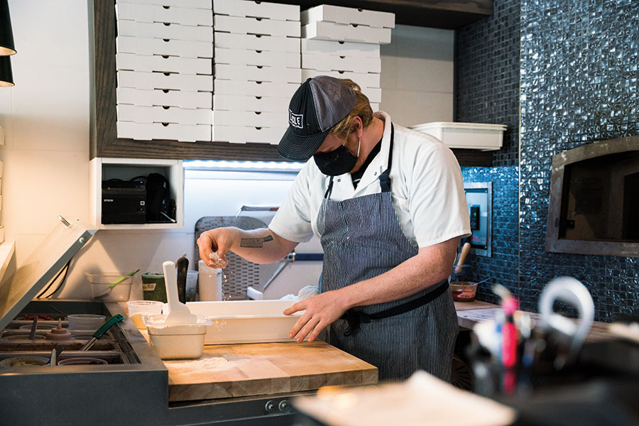 Pizza Chef Alex tossing up some vegan magic, photo taken by Wyatt Kostygan.